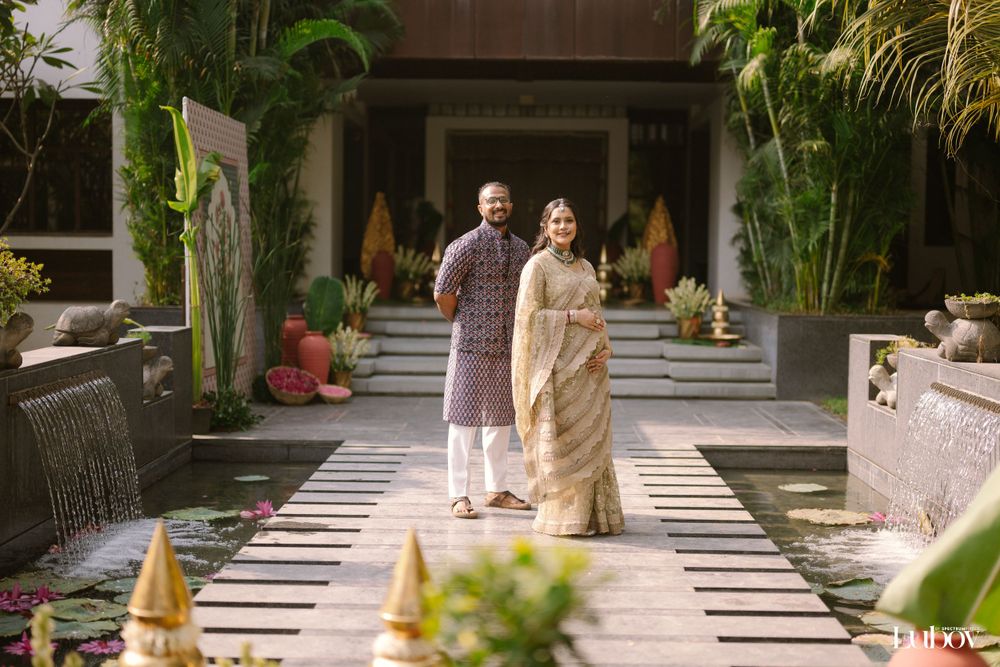 Garden walkway decorated with tropical plants and golden ornaments for a celebration.