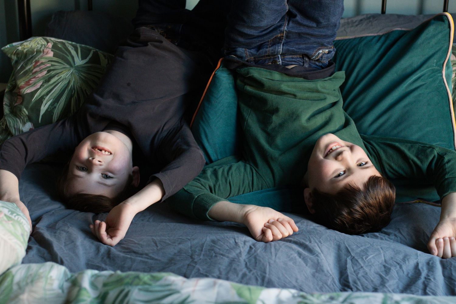 A sequence of playful moments captured on a green couch in natural lighting.