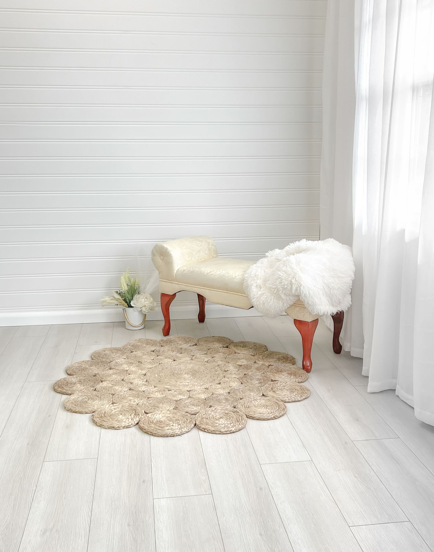 A plush decorative area rug appears at different angles on a light wooden floor.