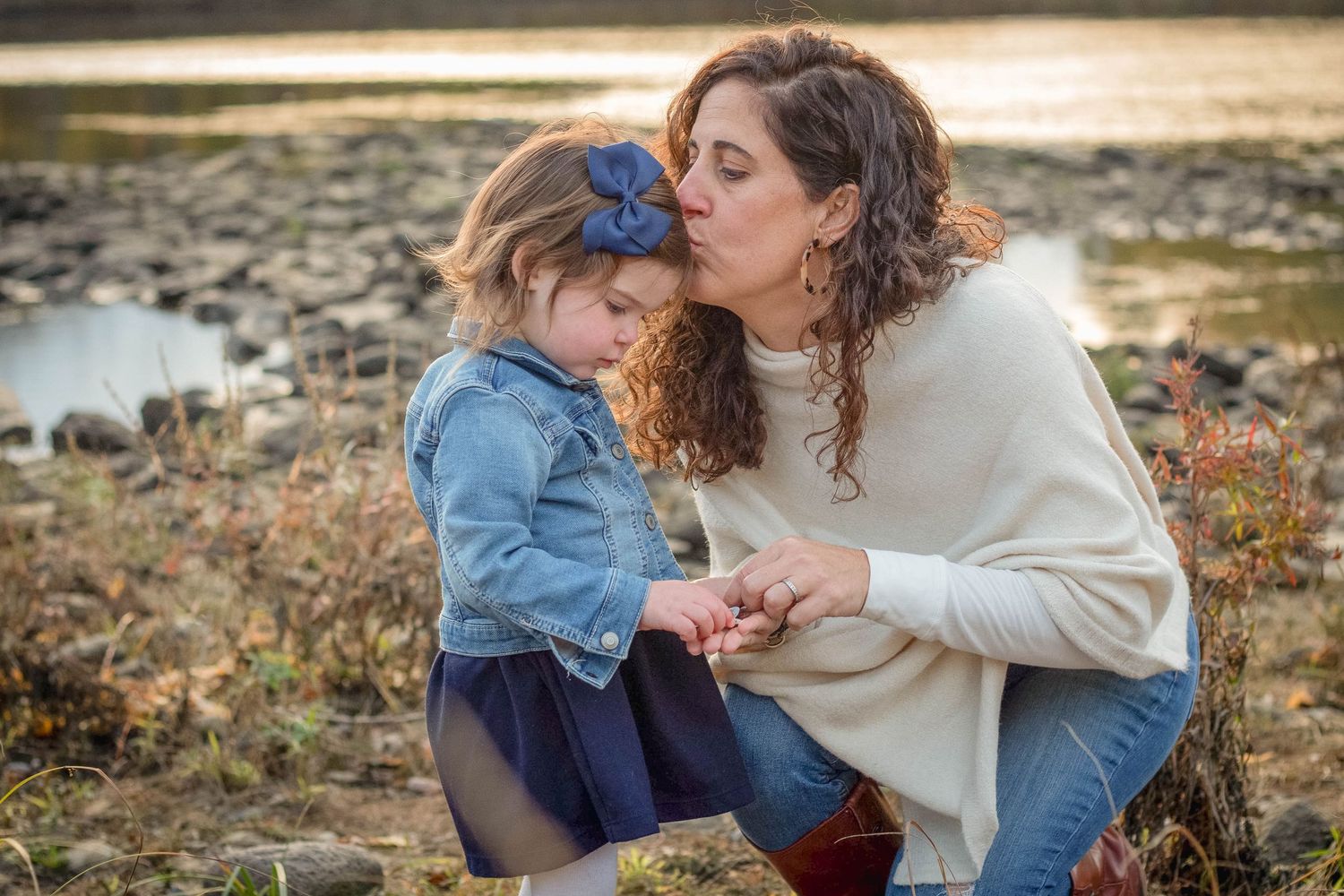 A tender moment between parent and child captured in a series of outdoor autumn photographs.