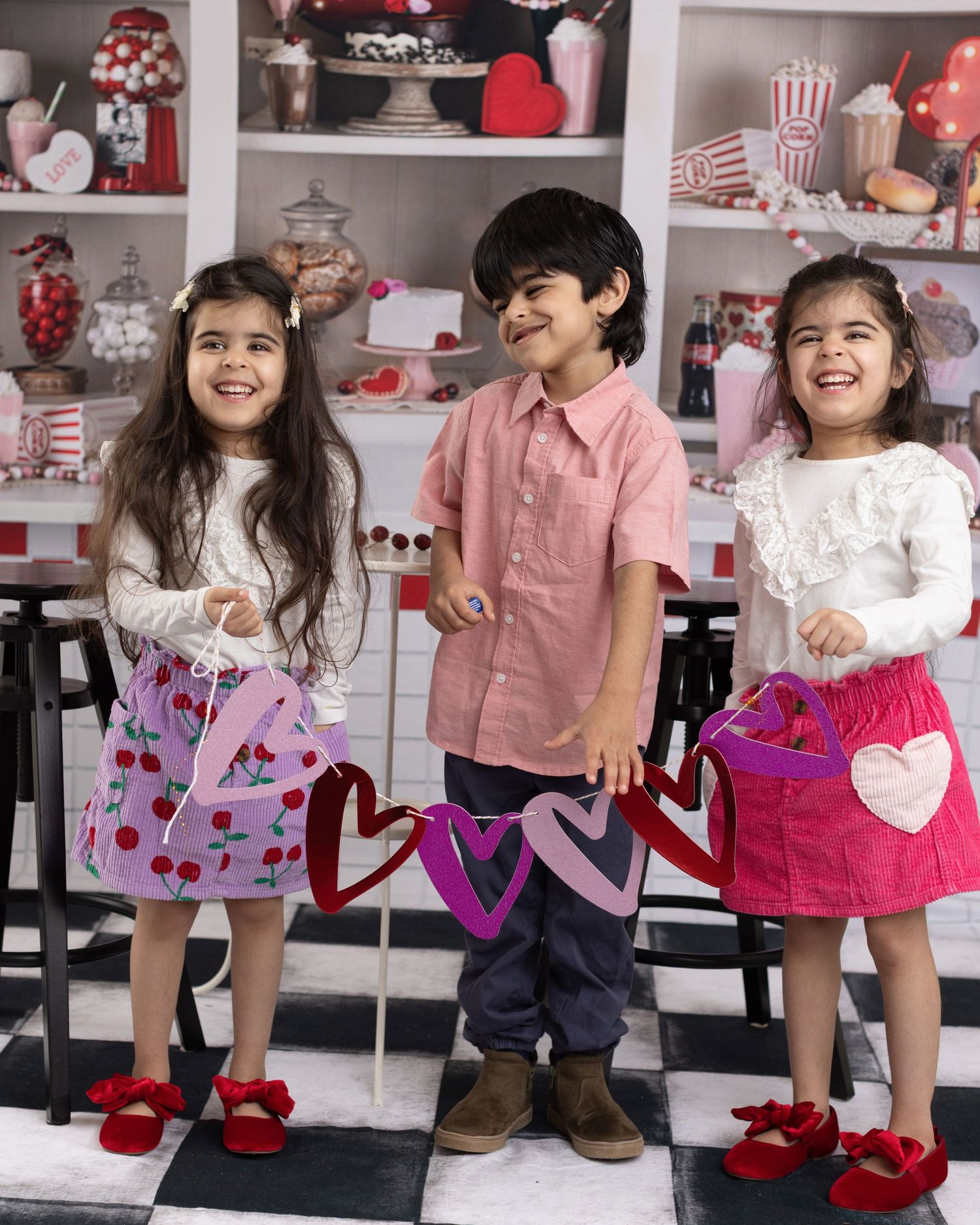 A series of Valentine's Day themed photos showing children in pink and red outfits with heart decorations and festive props.