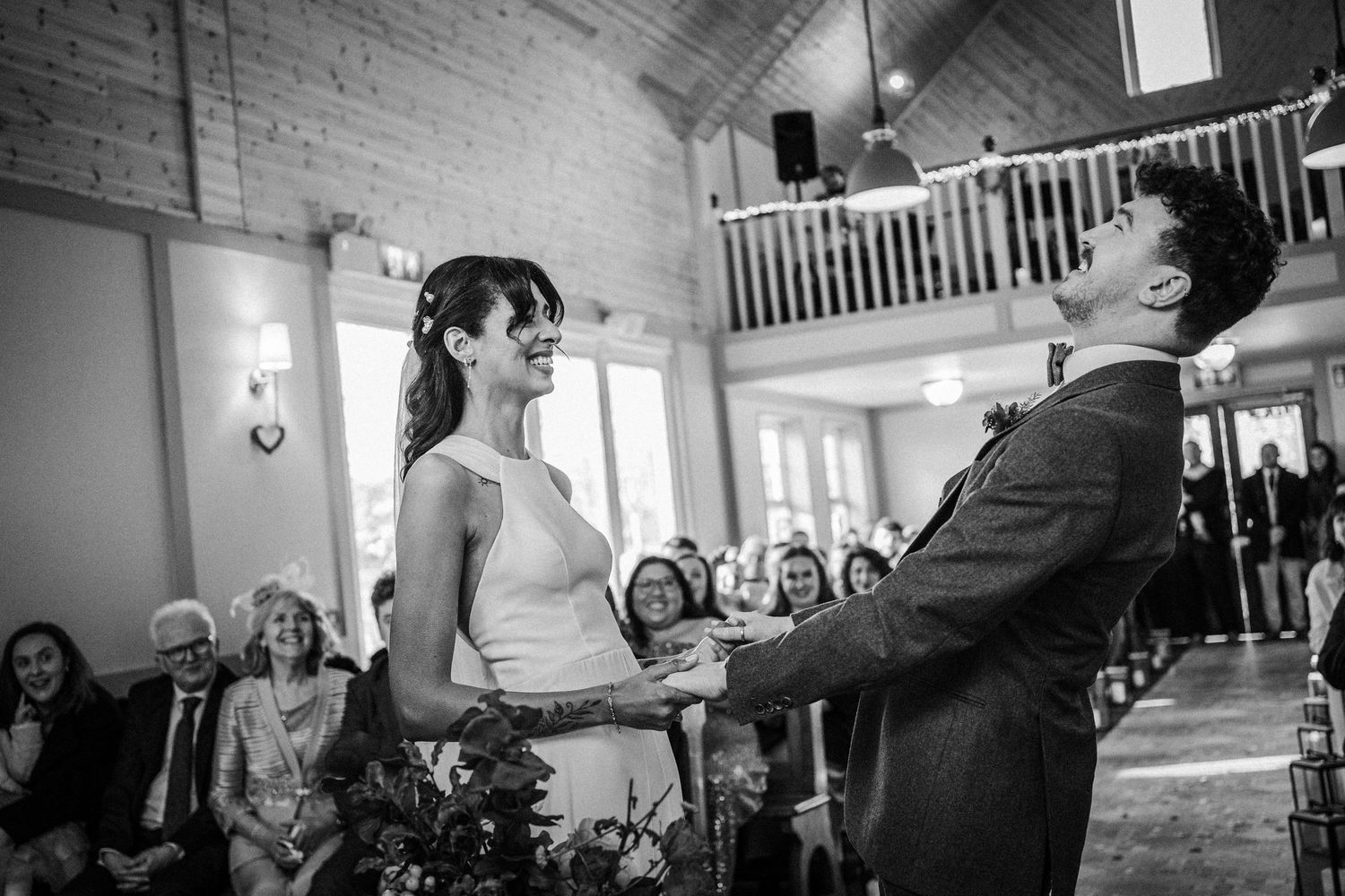 A series of black and white candid moments showing people dancing and interacting at what appears to be a wedding reception.