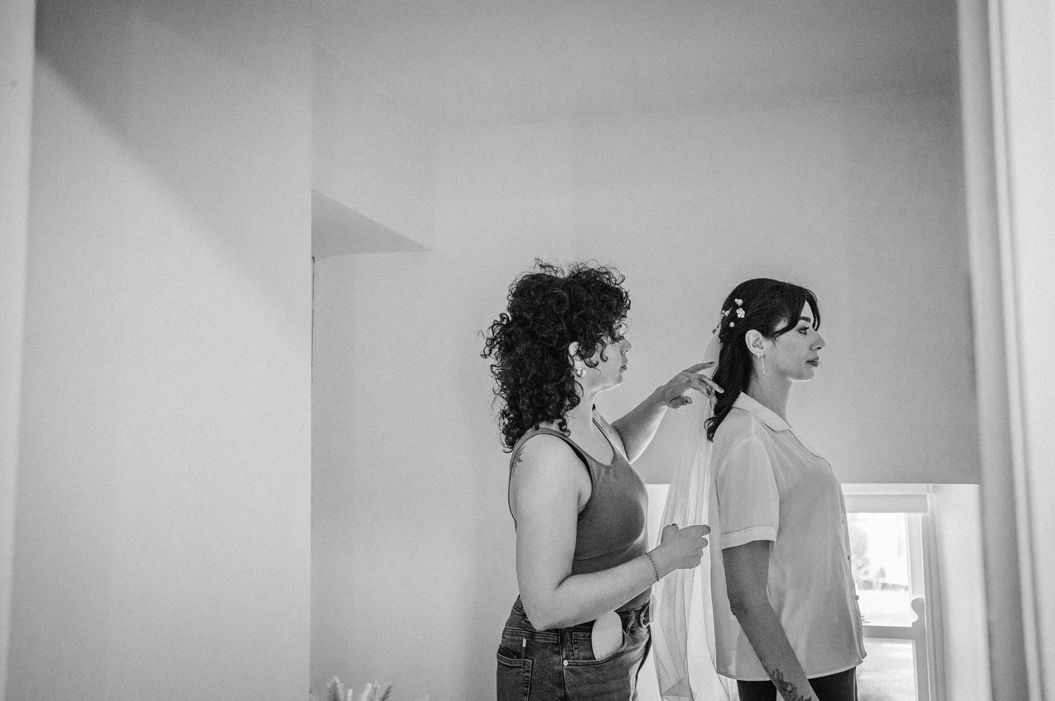 Black and white photo collage showing a person getting ready in front of a mirror in various poses and angles.