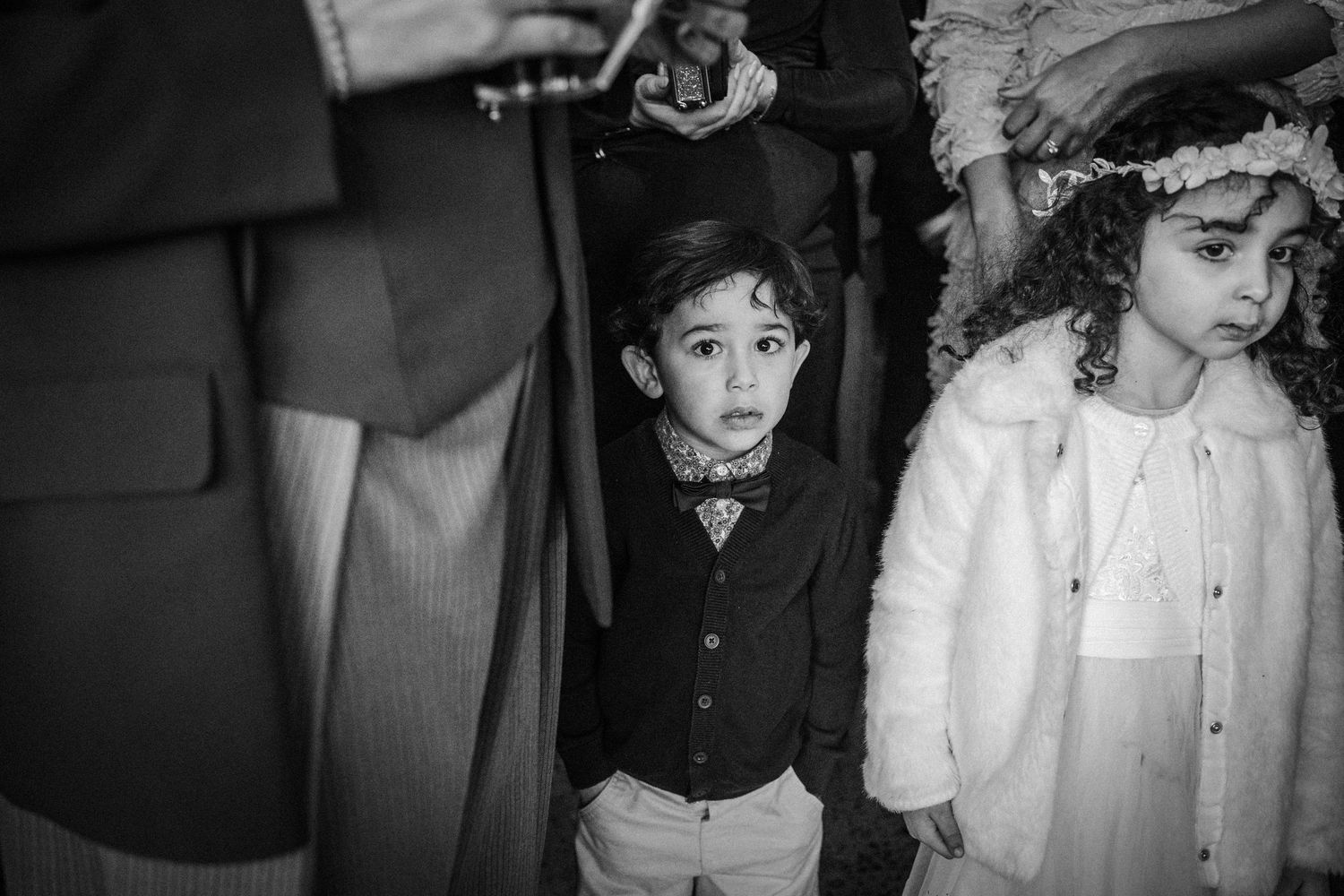 A black and white collage strip showing children in formal attire posing together in various groupings.