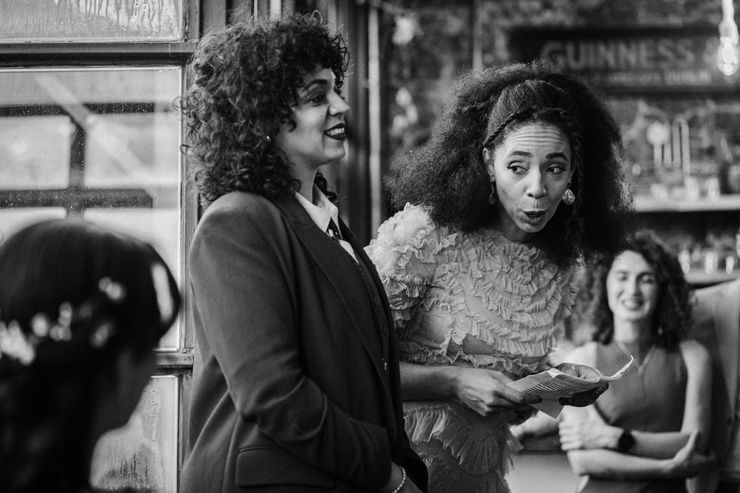 A series of black and white photographs showing people having conversations at a bar or restaurant counter.