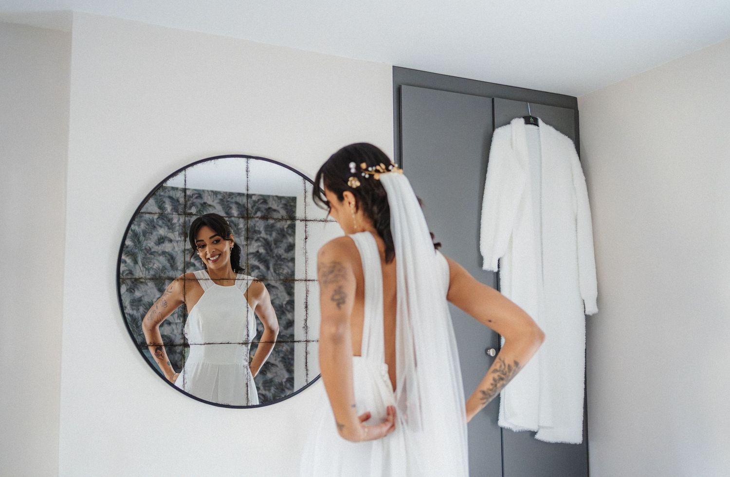 A collage of five images showing a wedding dress fitting session in a bridal boutique with mirrors and white decor.
