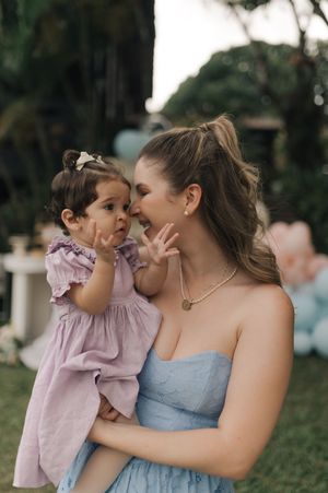 Candid moments captured outdoors showing tender embraces and laughter against a natural backdrop.