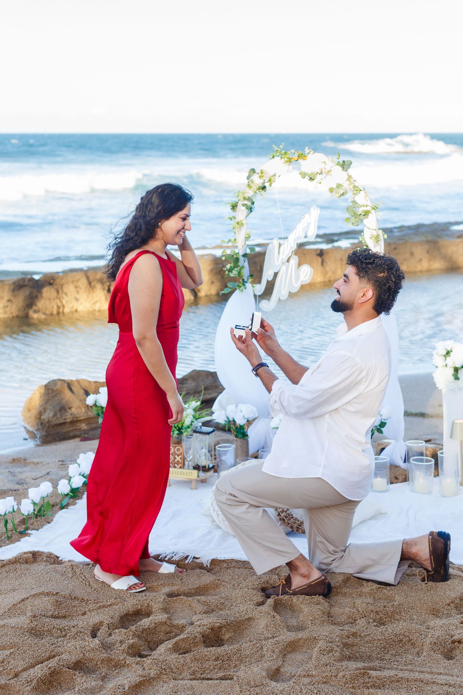 Couples portrait. Proposal and engagement session. Man and woman on the beach. Man down on knee. Kikita Surf Beach, Dorado, Puerto Rico.