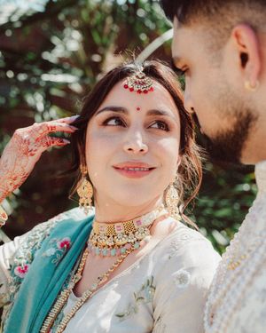 Close-up shots of a couple in traditional Indian wedding attire with ornate jewelry and decorative details.