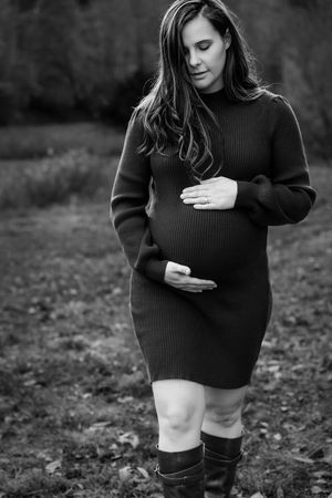 A series of black and white photos showing someone wearing a black sweater and boots sitting on the ground.