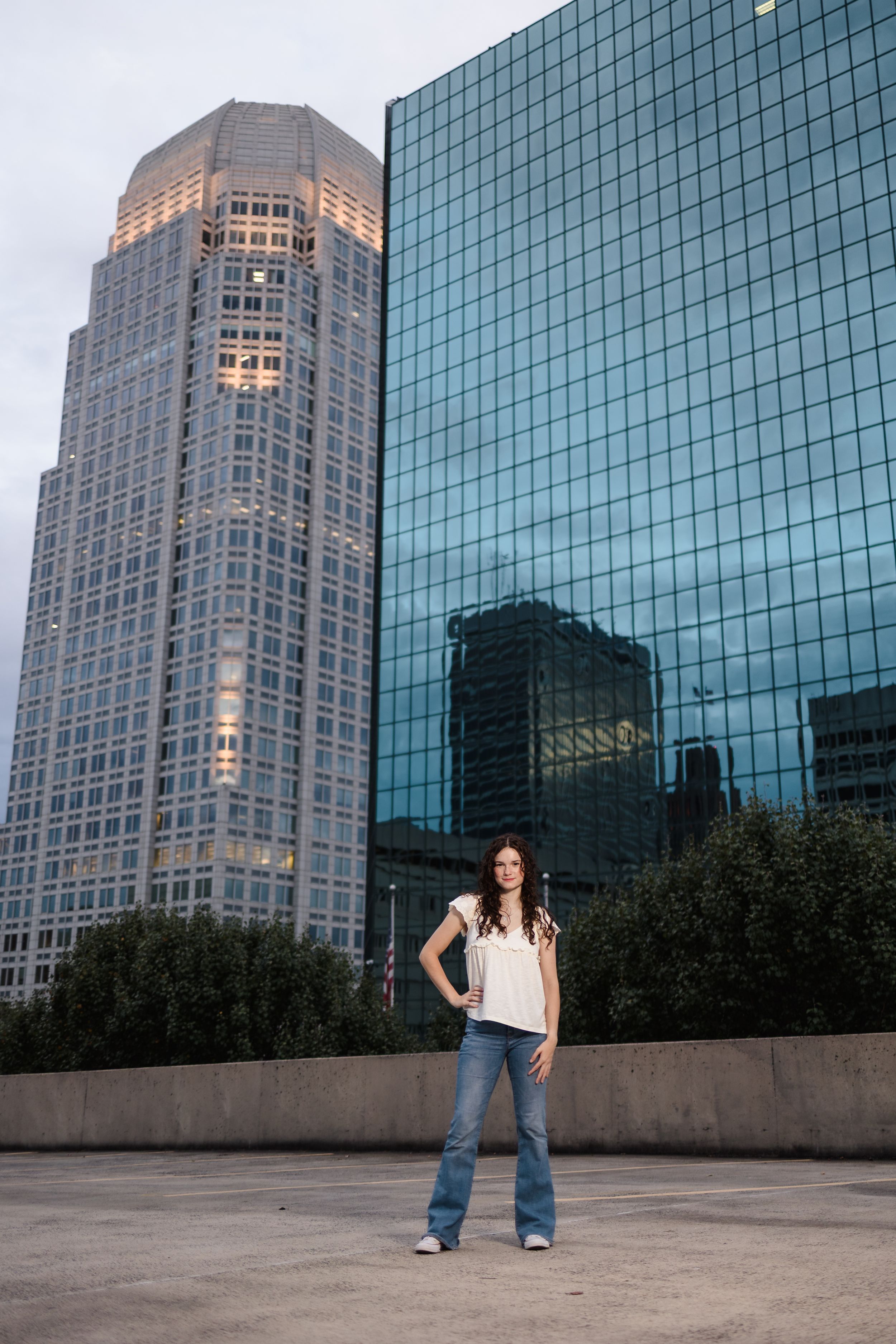 Urban portrait session with glass skyscrapers and modern architecture in the background.