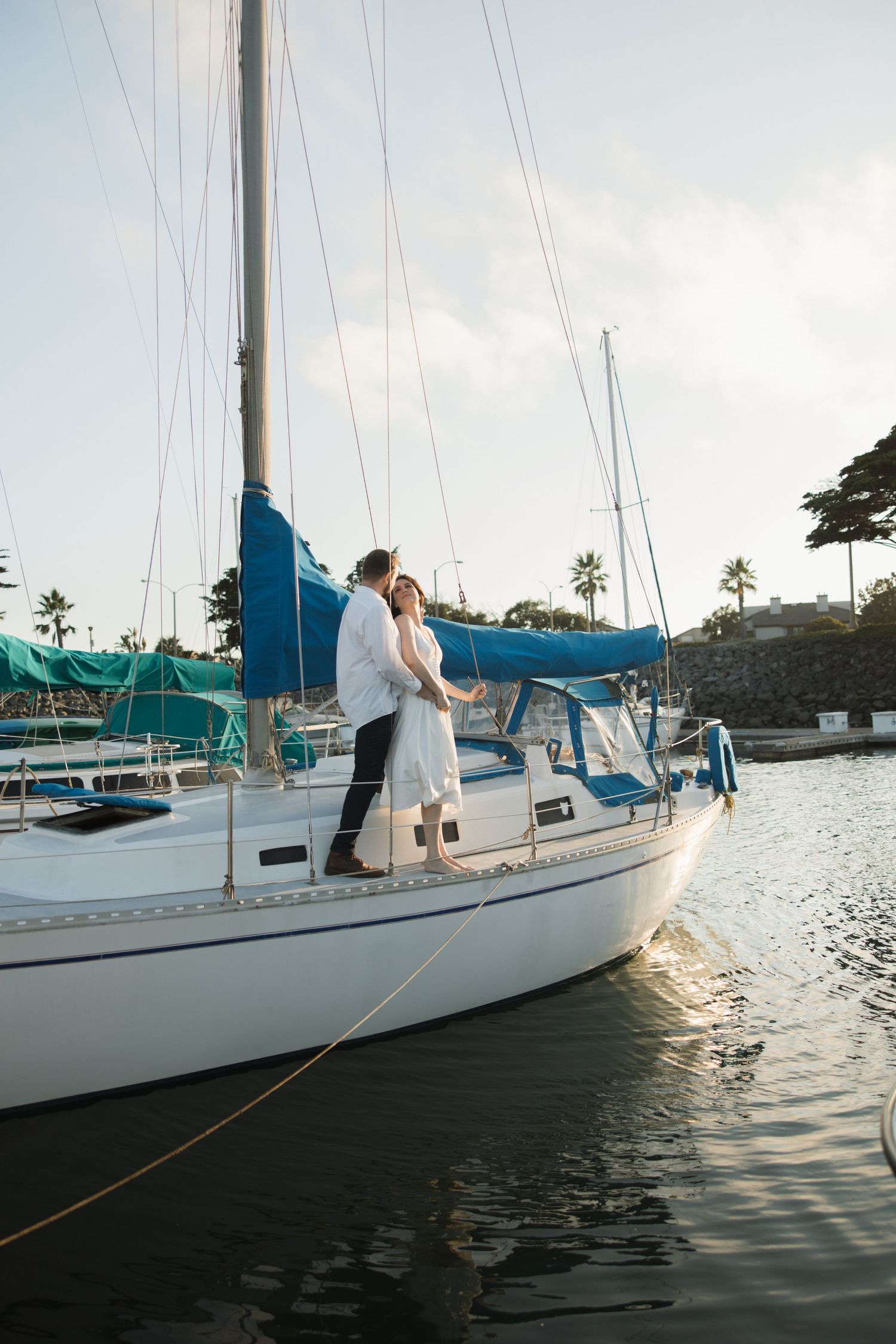 Wide shot of engagement session on a sailboat off the coast of Ventura