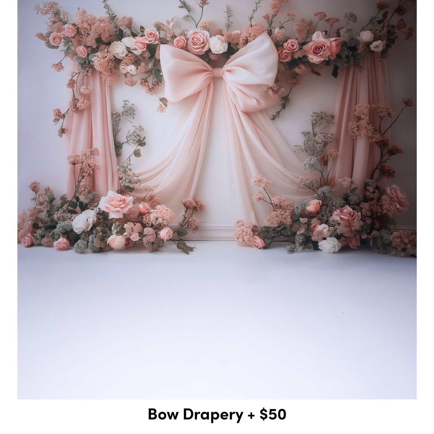 Elegant pink fabric drapery and floral arrangements create a soft, romantic backdrop against a white floor.