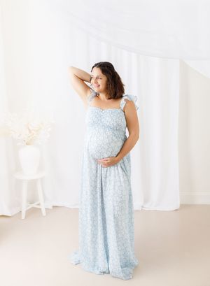 Light blue floral maternity dress shown in multiple angles against white backdrop.
