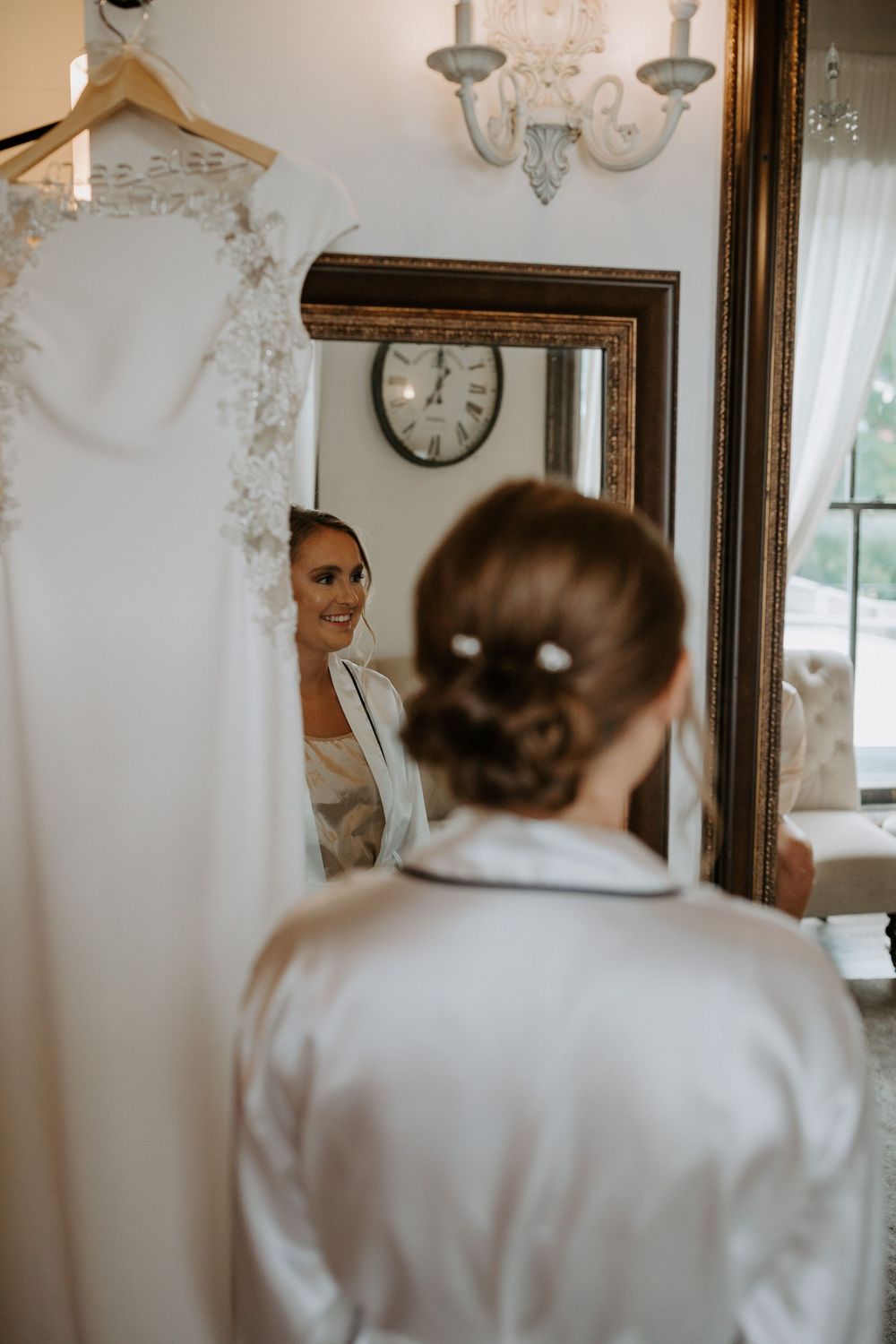 Elegant dressing room with crystal chandelier and vintage mirror.