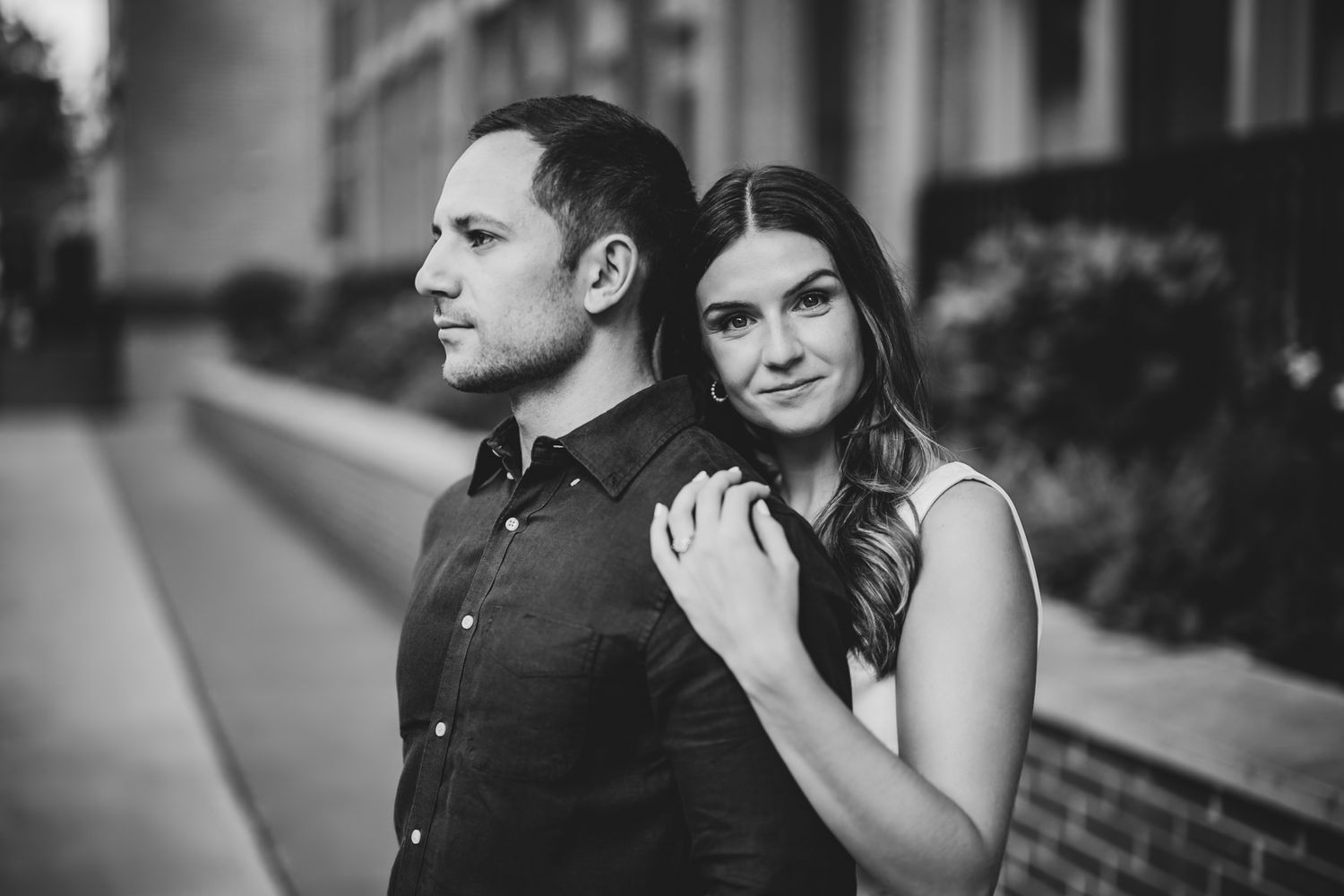 Black and white portrait series of couple sharing tender moments outdoors.