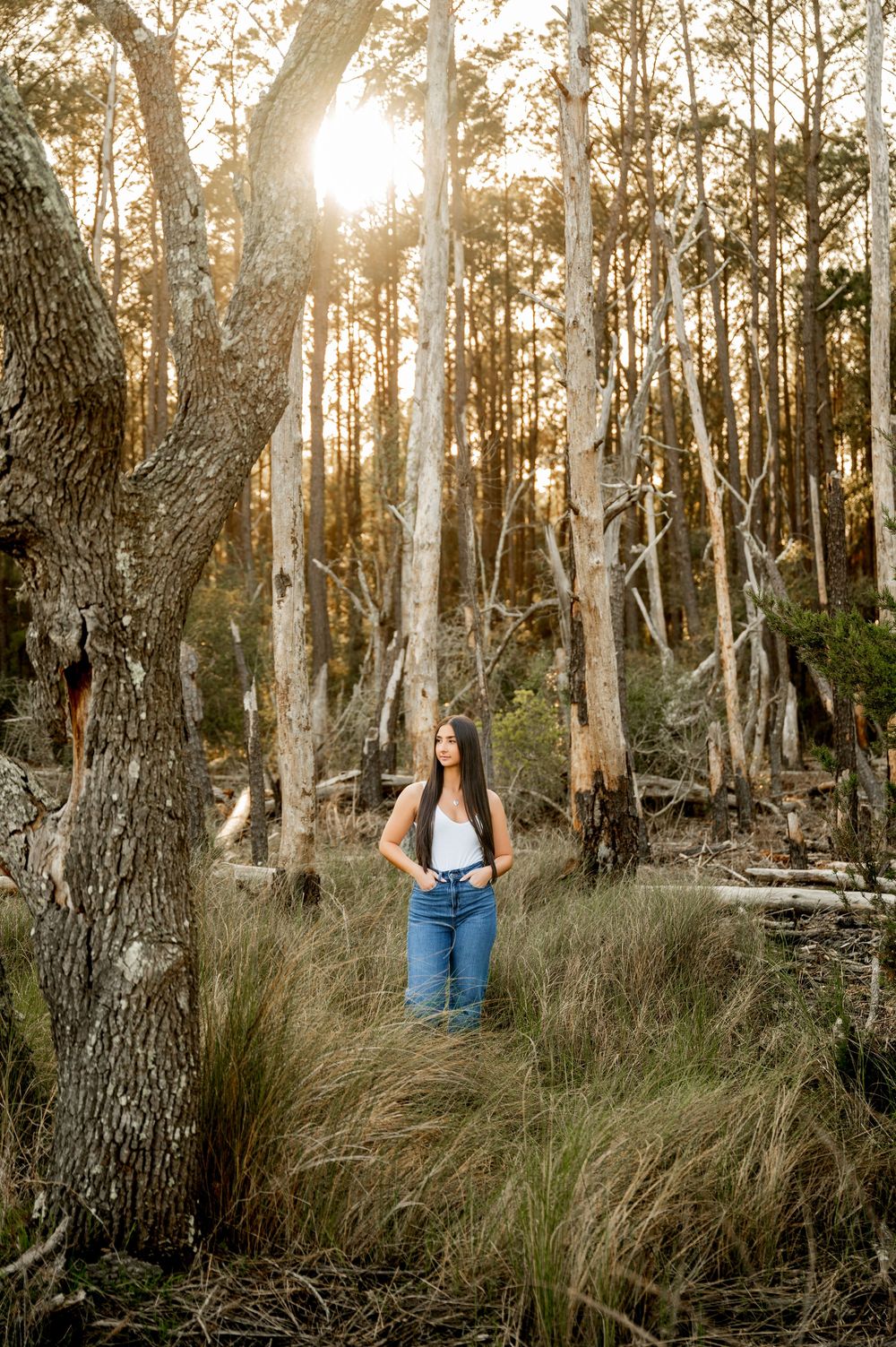 Sunset portrait session among eucalyptus trees and wild grass in a natural setting.
