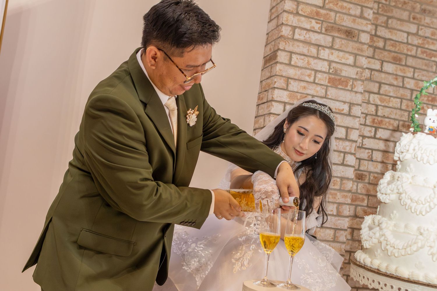 Groom pouring champagne for the bride during a wedding reception in Magnolia, Texas, capturing a heartfelt moment at the reception