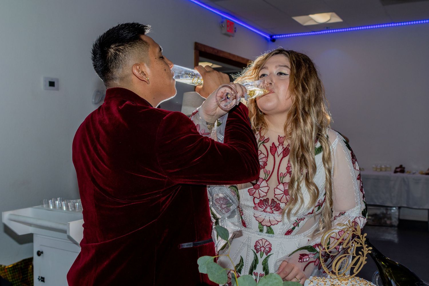Bride and groom sharing a champagne toast at their reception in Quinlan, Texas, celebrating their wedding day in formal wedding attire.