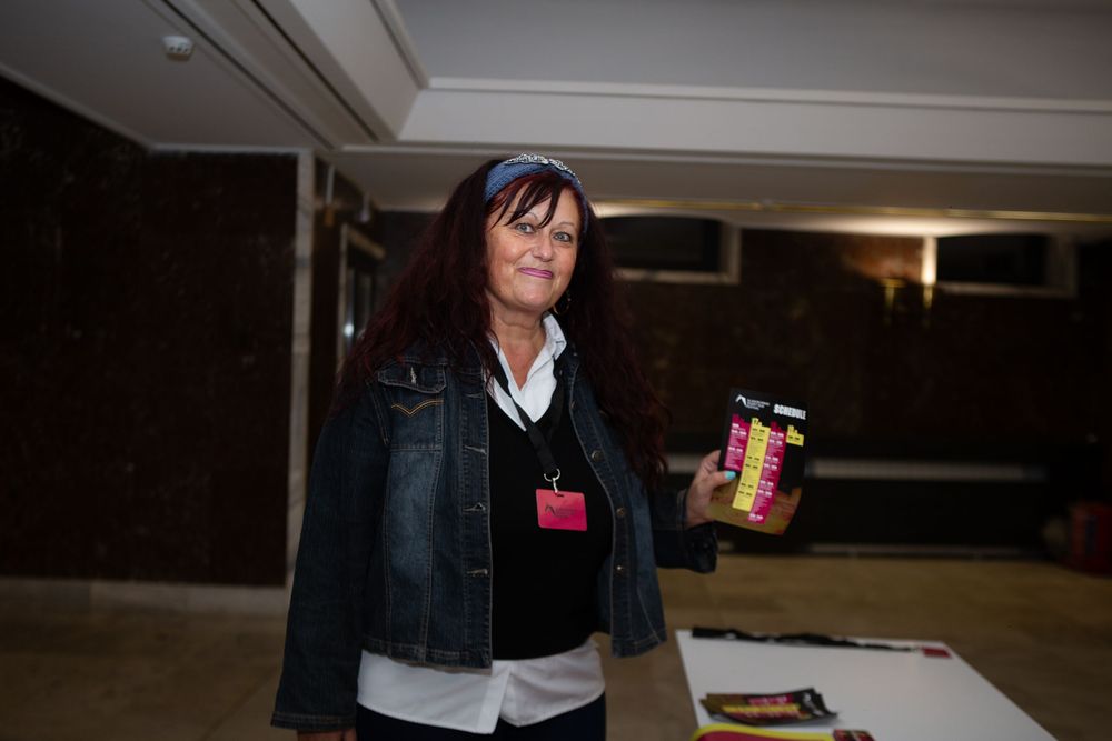 Woman with red hair holding a jar at the Blagoevgrad Short Film Festival event.