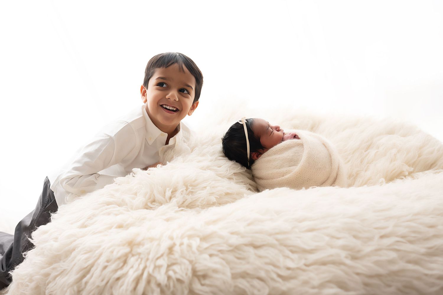 A person relaxes comfortably on a plush white shag rug or carpet.