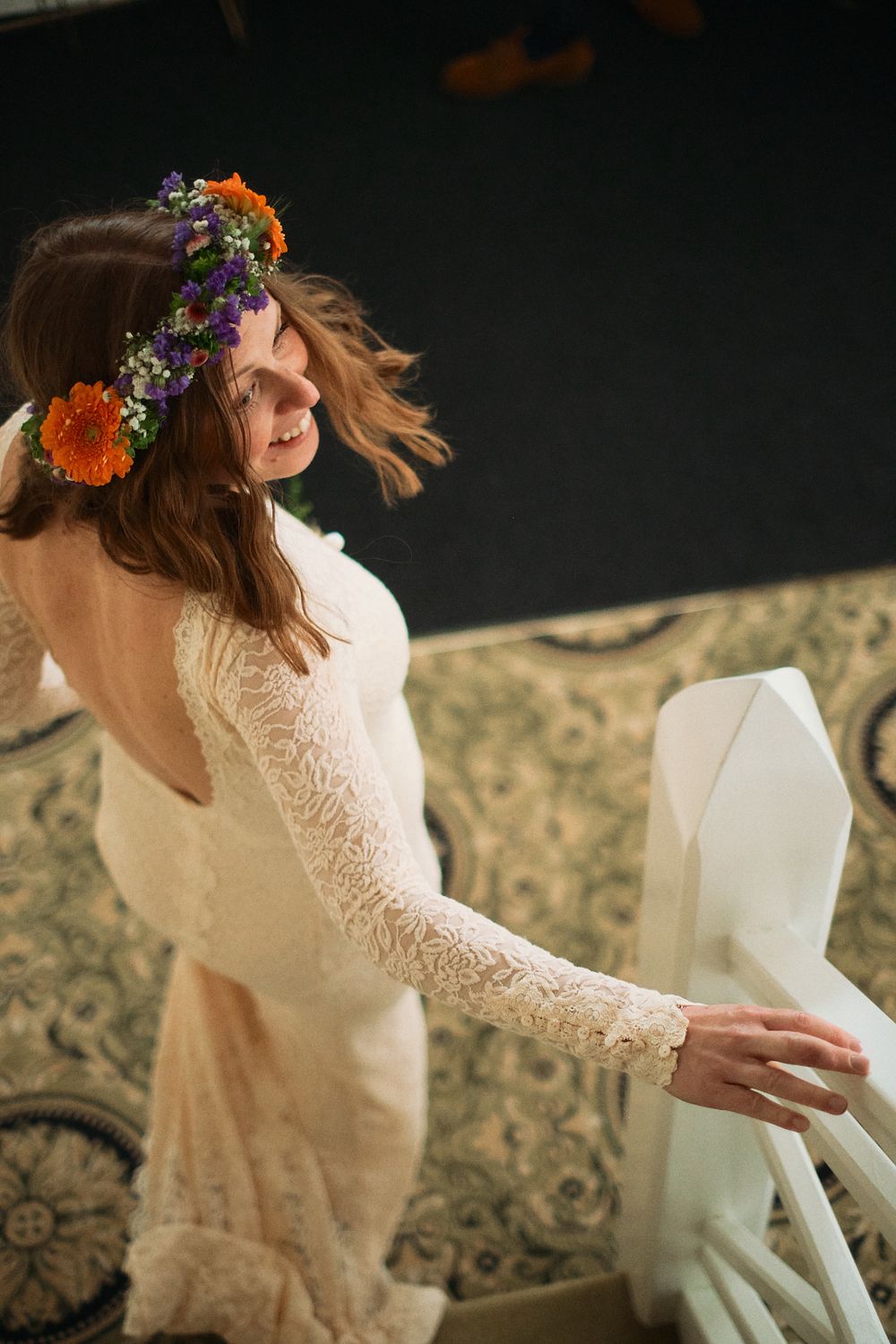 A bride in a lace dress and floral crown sits on a patterned couch in a sequence of artistic motion shots.