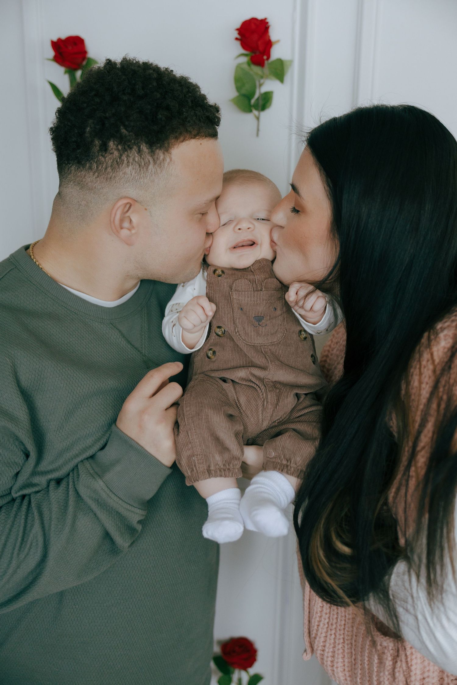 A sweet family moment captured in a series of intimate photos with red roses and gentle kisses.