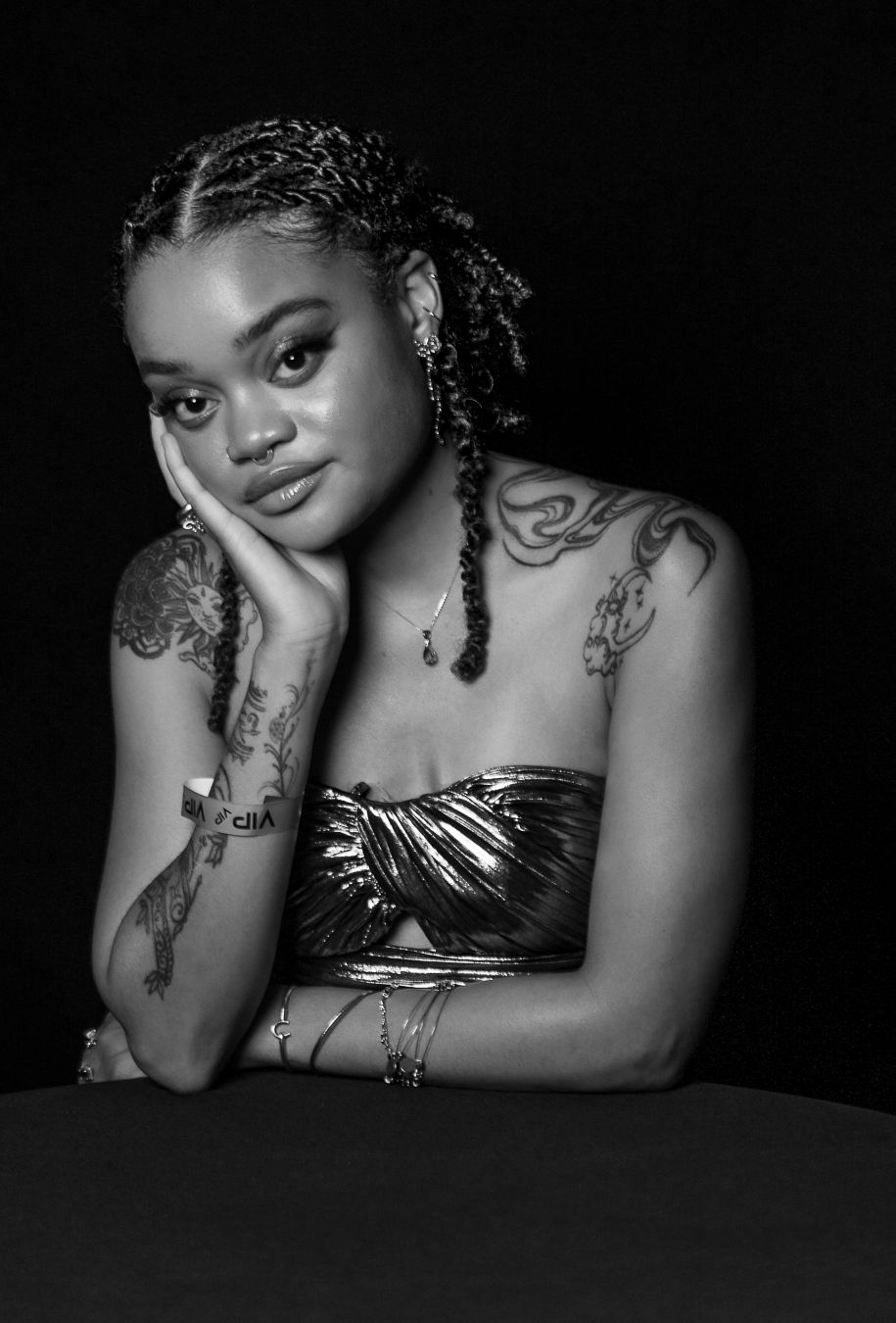 A dramatic black and white portrait series showing artistic poses against a dark background.