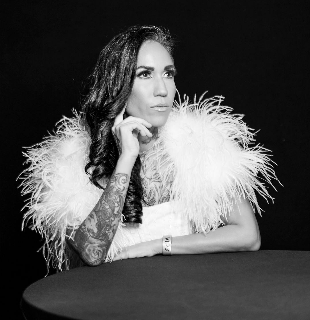 Glamorous photo series featuring white feather boa accessories against dark backdrop.