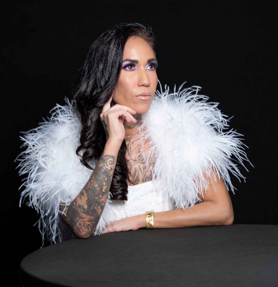 Glamorous studio portraits featuring white feather boa accessories and elegant styling against black backdrop.