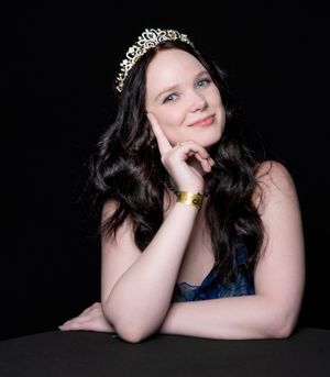 A series of artistic portrait shots against black background showing poses with dark hair and blue top.