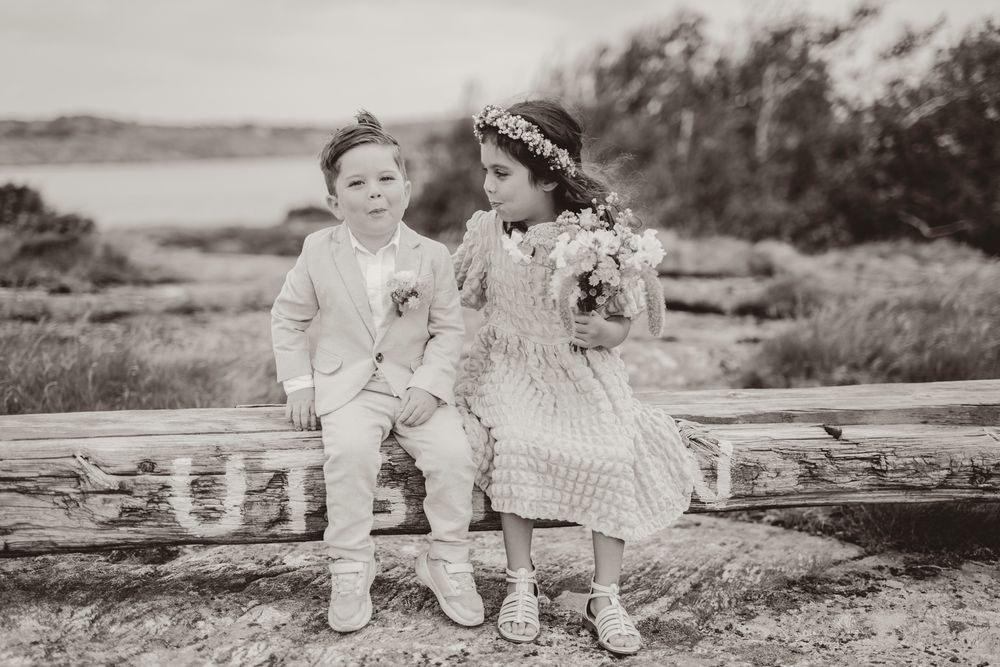 A series of vintage black and white photographs showing children sitting and playing outdoors in classic clothing.