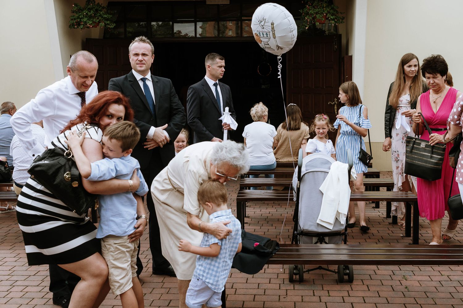 Wedding guests dance and celebrate together at an outdoor reception venue.