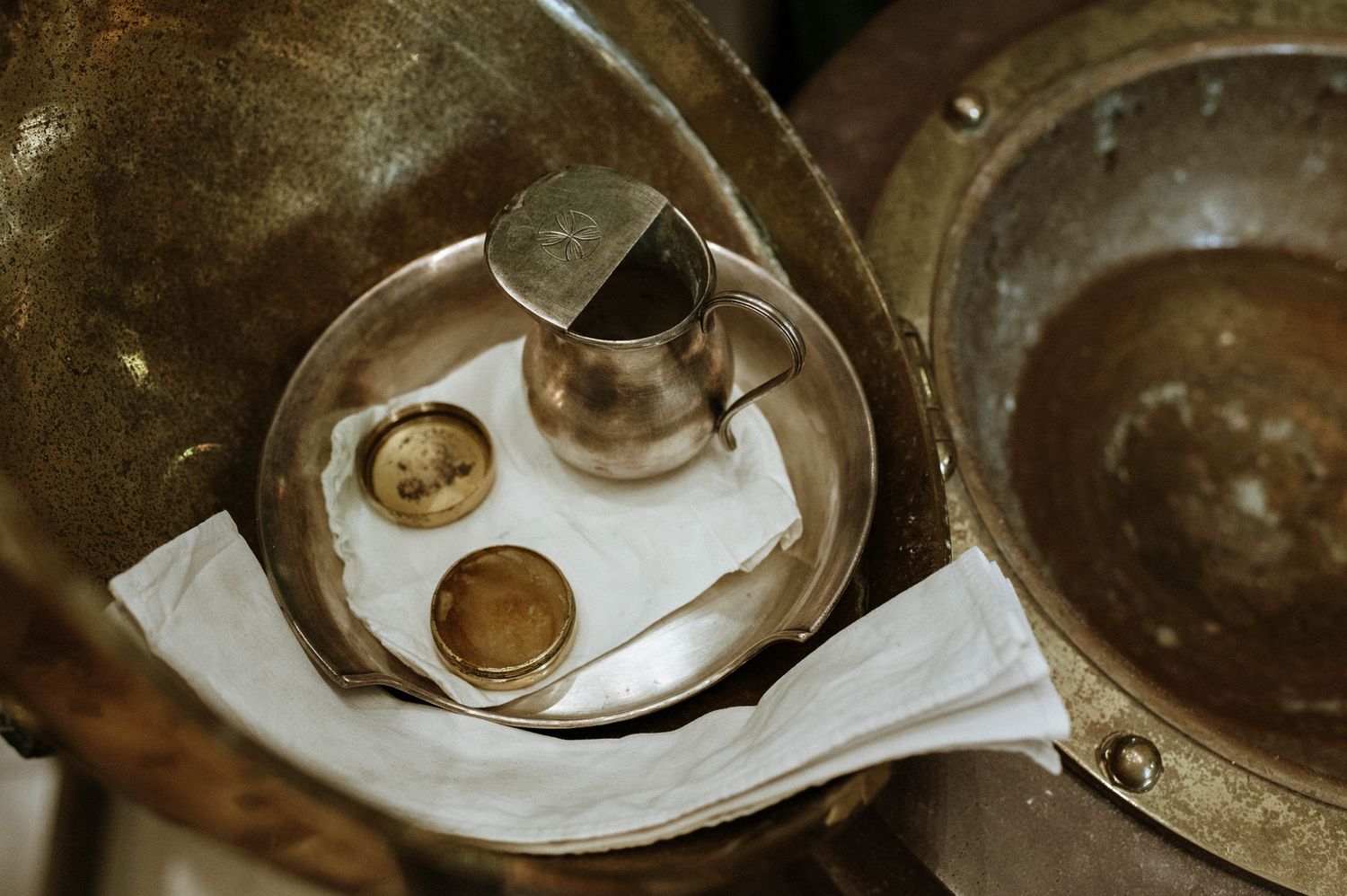A sequence of vintage teacups and saucers arranged in a row showing different antique designs and patterns.