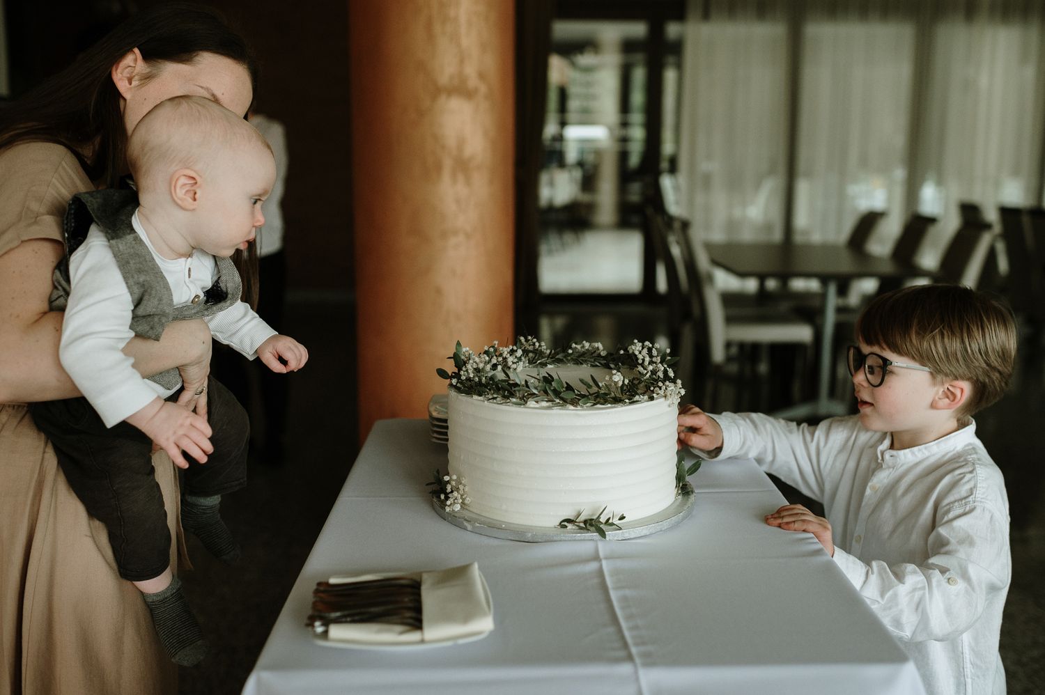 A collage of wedding cake cutting moments shows guests and family members gathered around a white tiered cake.