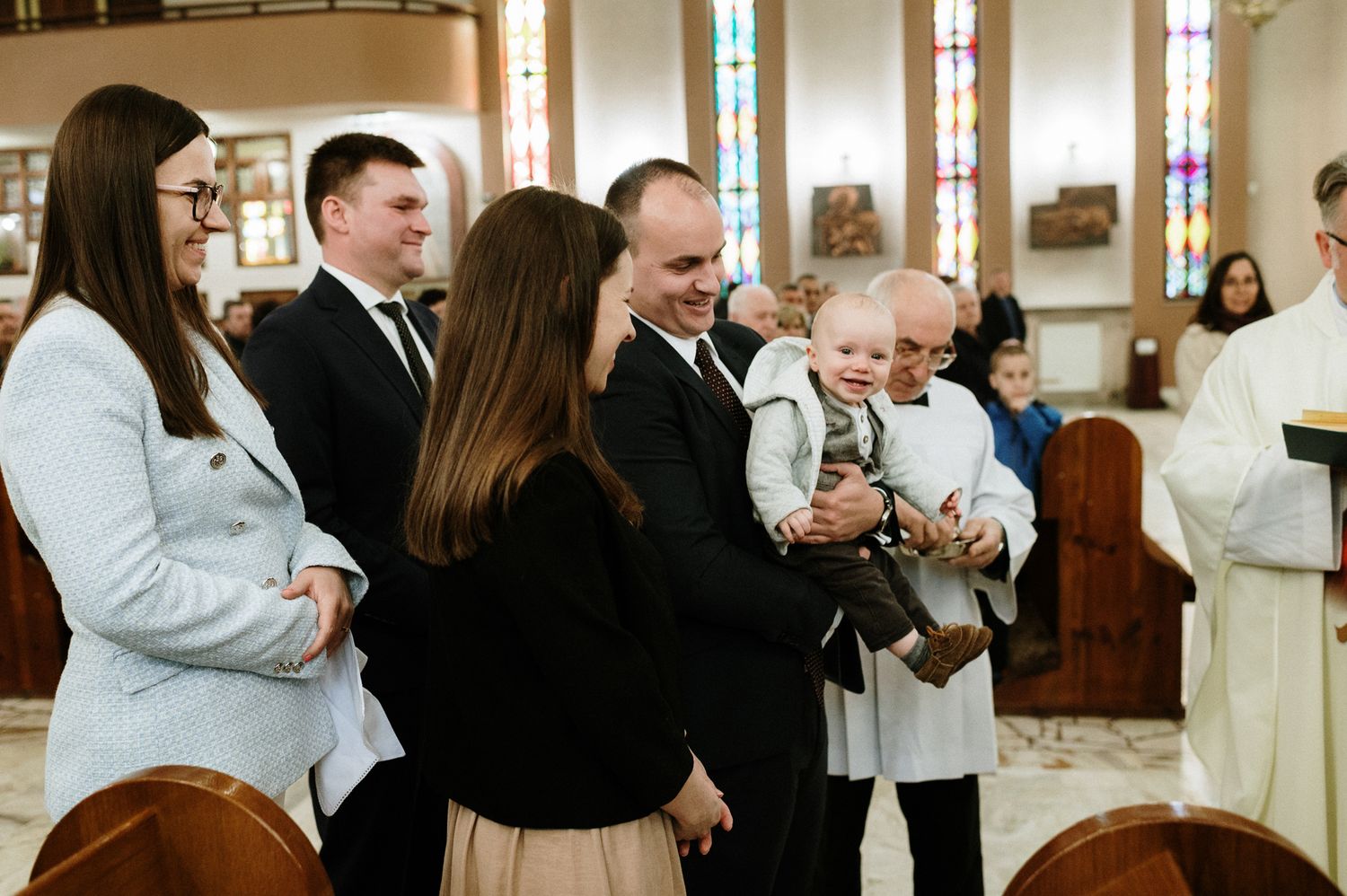Wedding ceremony guests seated in church pews during celebration.