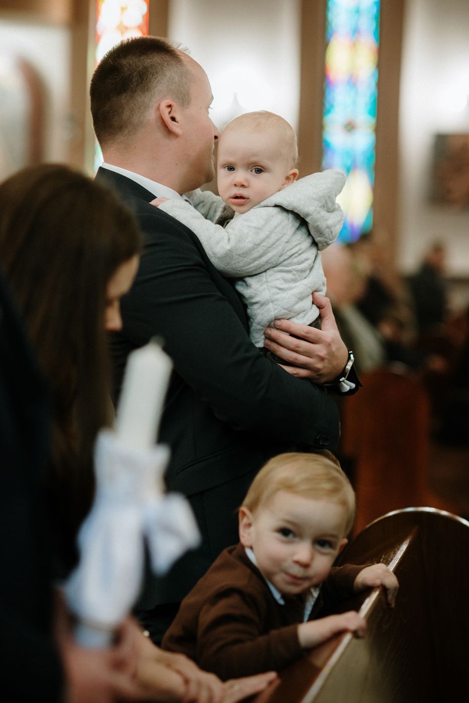 Series of candid church ceremony photos showing tender family moments during a religious service.