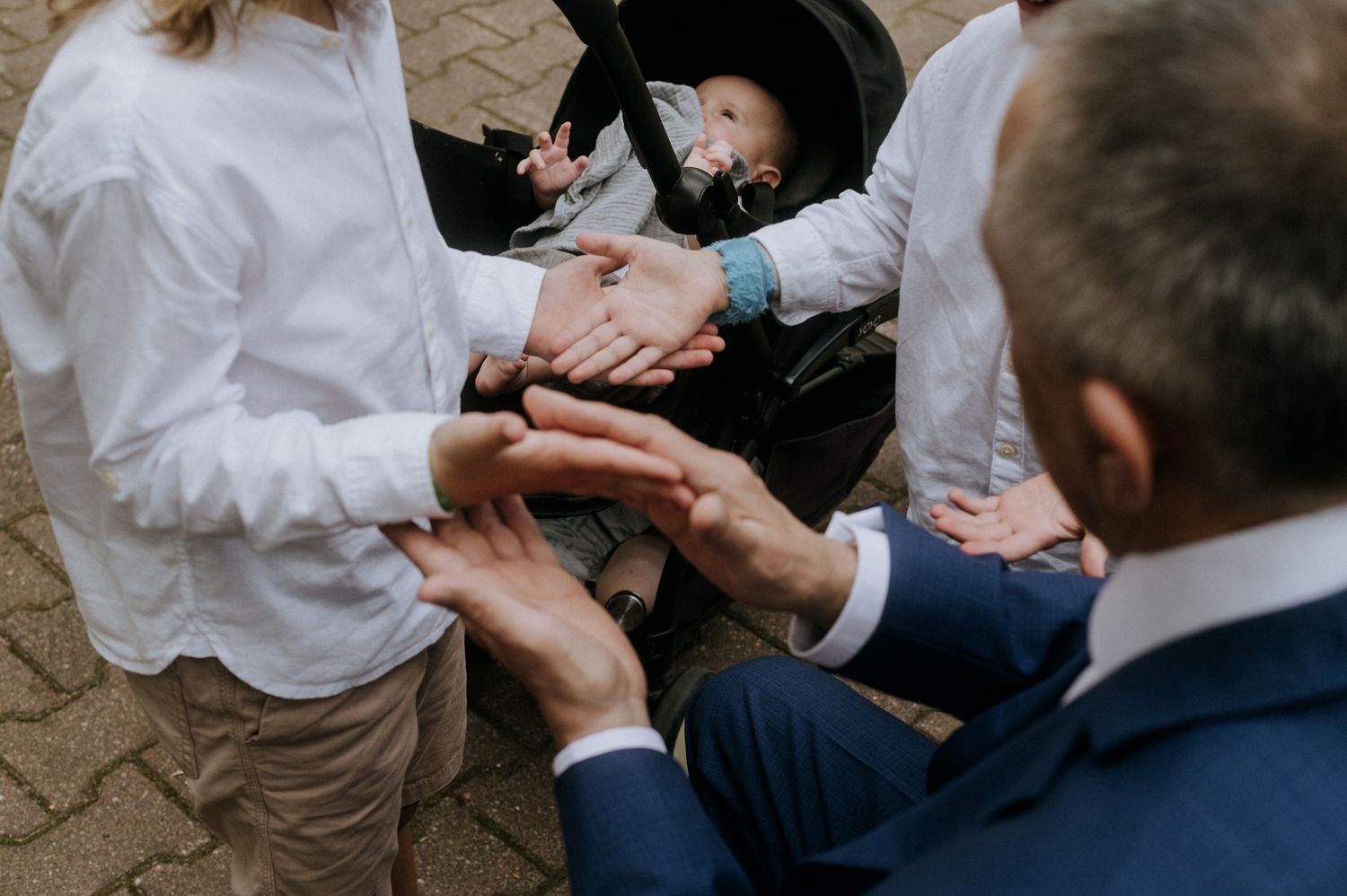 People's hands reaching out to grab cookies from a platter at a gathering event.