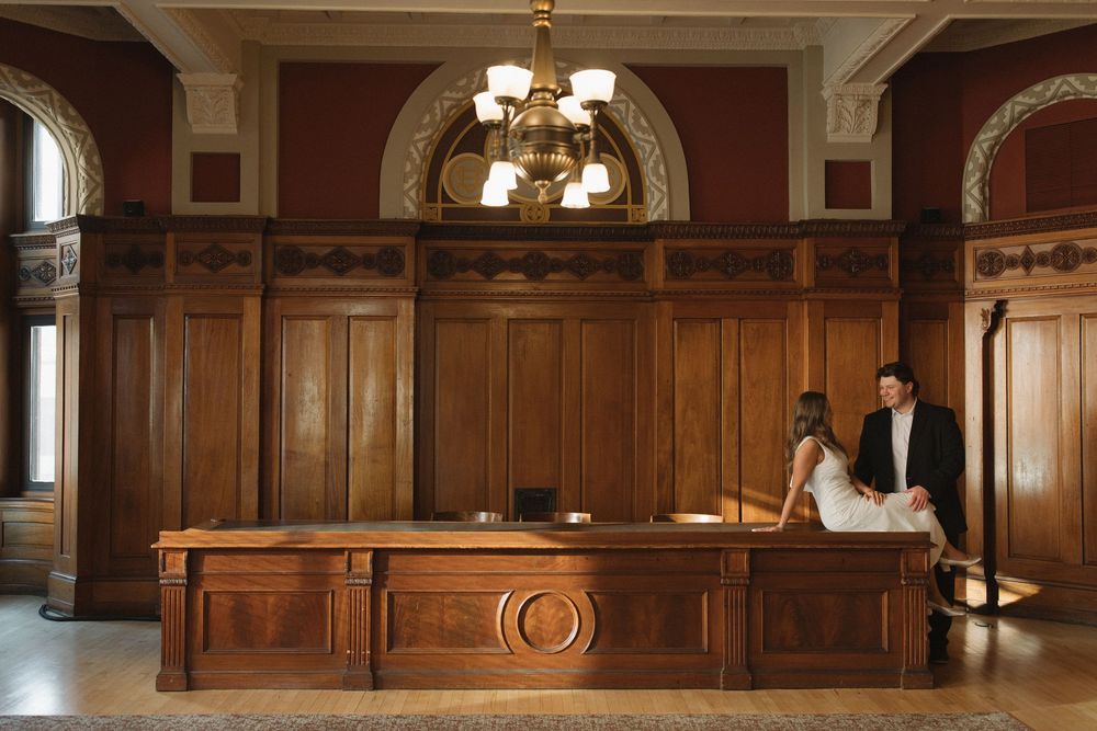Ornate wooden courtroom interior with traditional paneling and decorative details in classic architectural style.
