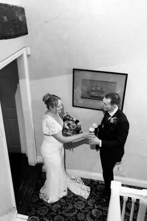 A sequence of black and white wedding photos showing a couple dancing and embracing at their reception.
