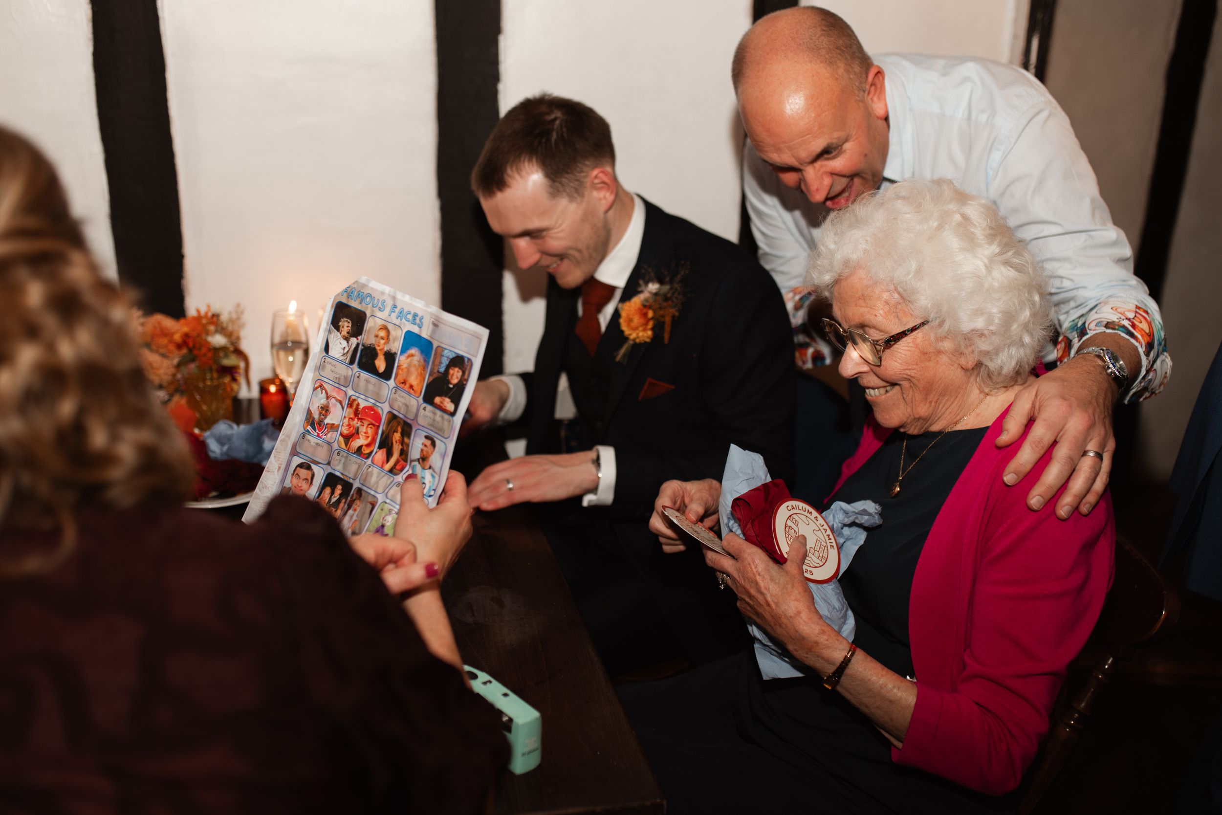 A sequence of photos showing people laughing and reacting emotionally while looking at something together.