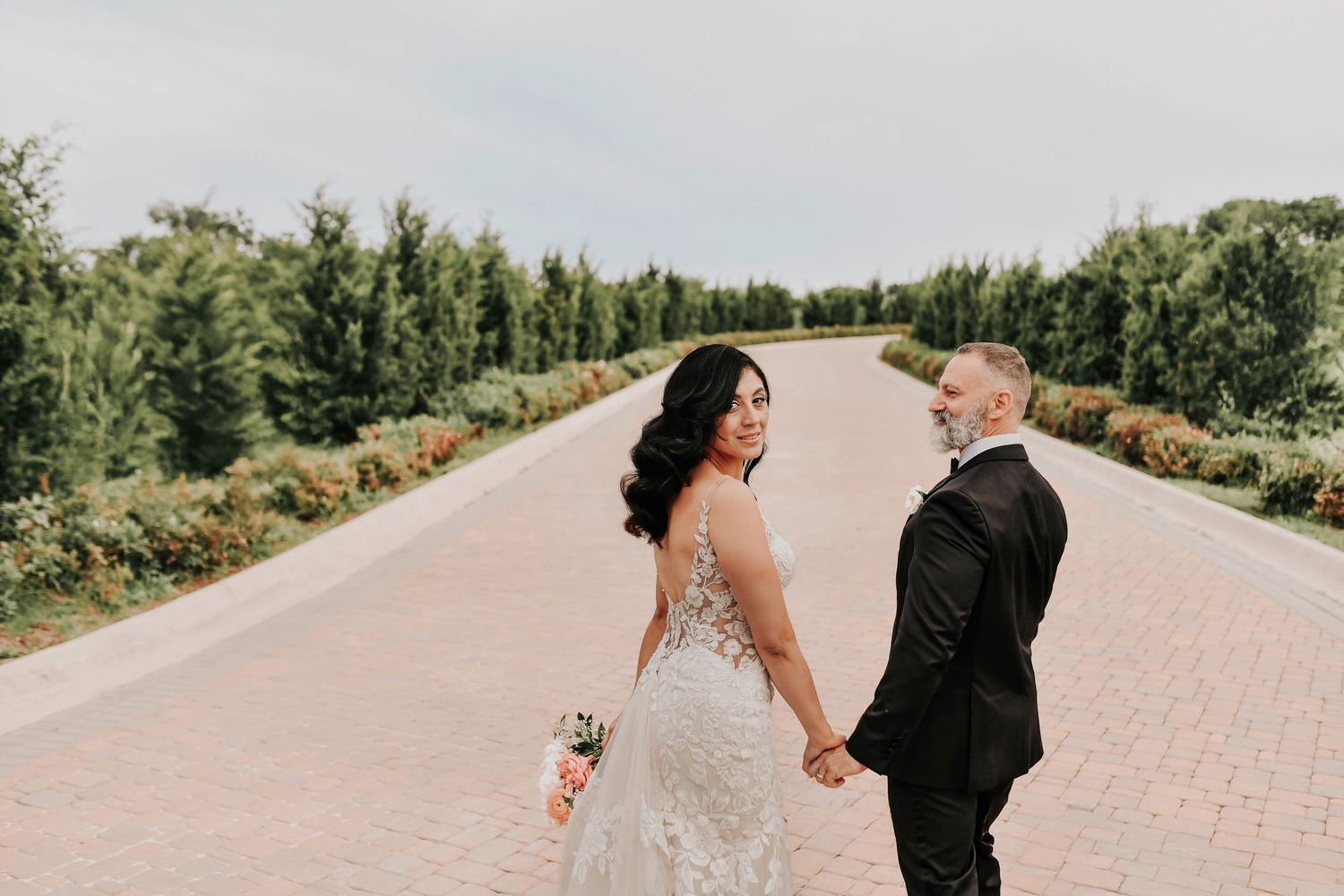 Newlyweds embracing near the stone chapel at D’Vine Grace