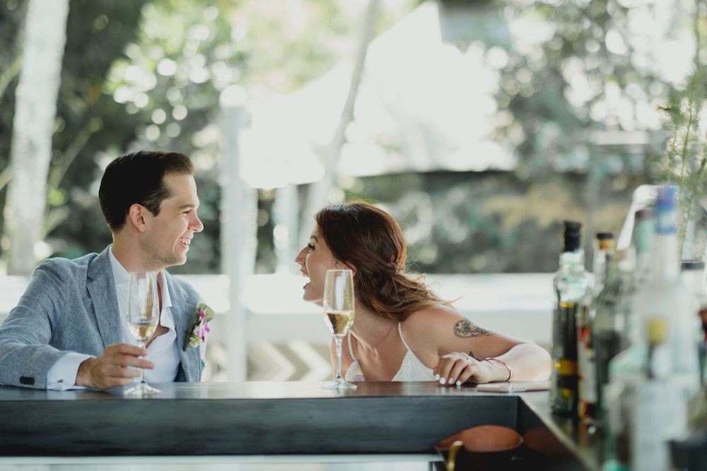Couple shares intimate moment at outdoor cafe table.