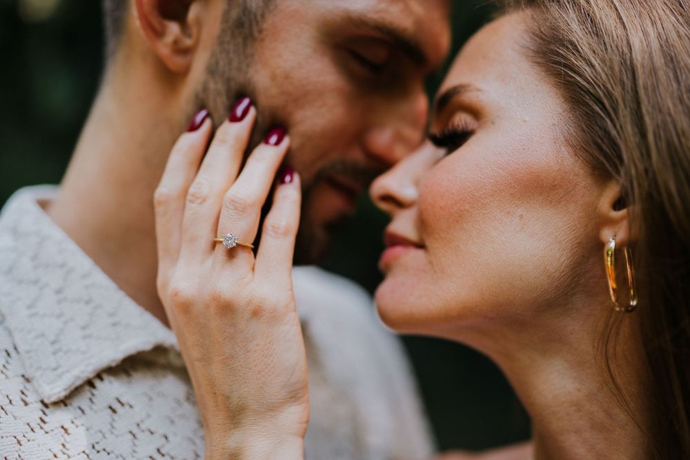 A close-up shot of two people sharing an intimate moment in natural lighting.