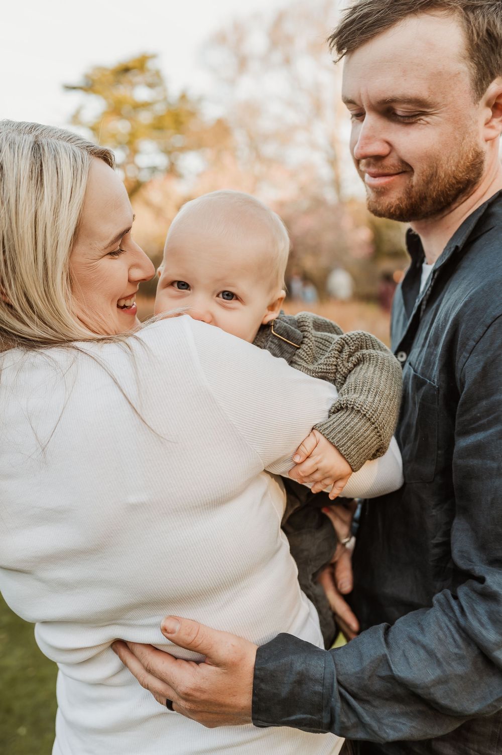 A warm and loving family moment captured in fall as they share a playful interaction in a series of candid photos.