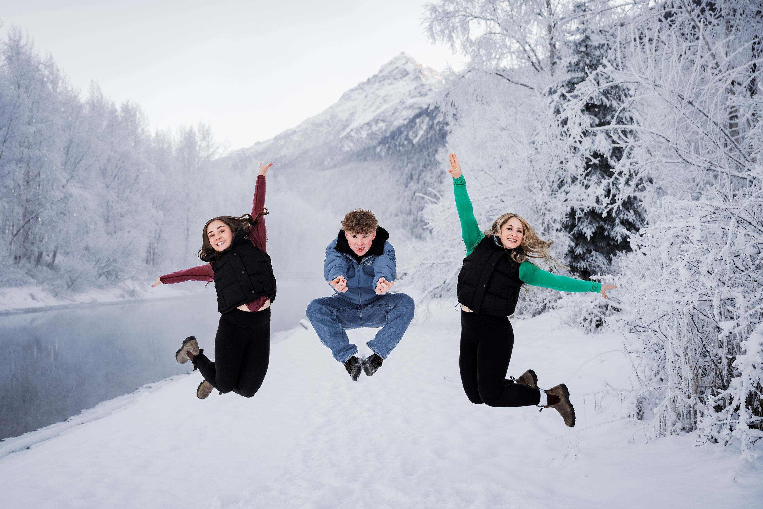 Snow-covered winter landscape with siblings that love to have fun.