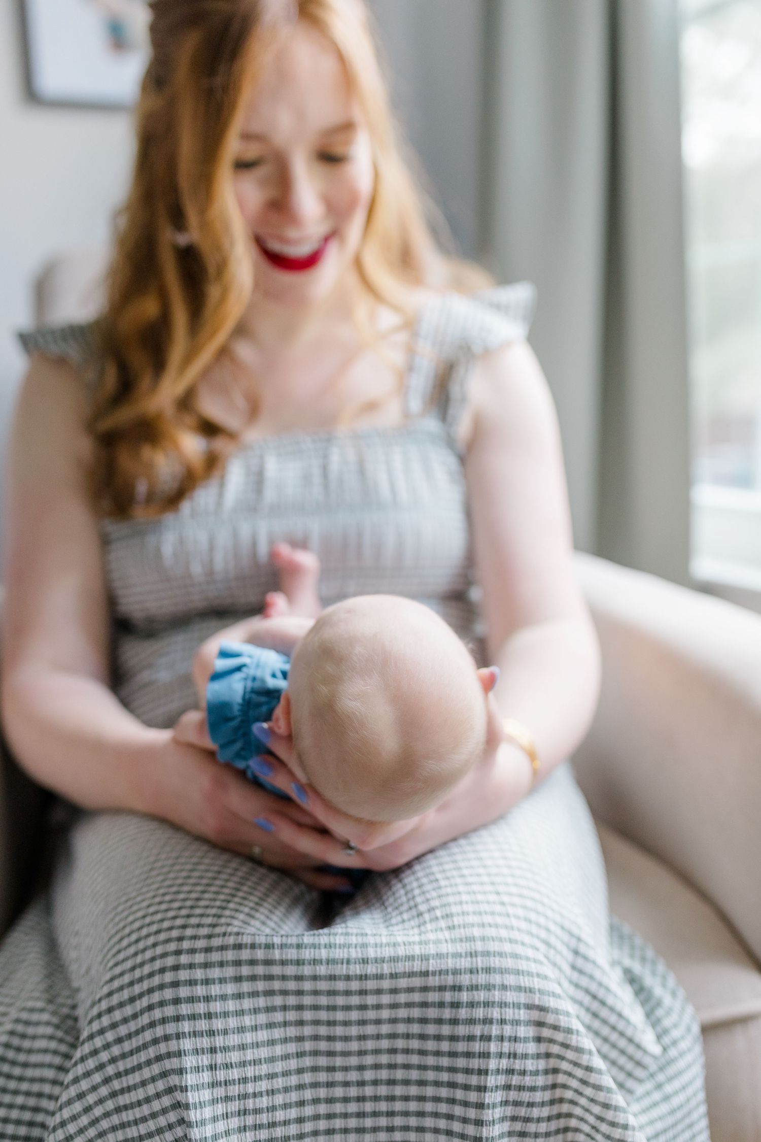 A tender moment between parent and baby in a cozy living room setting.