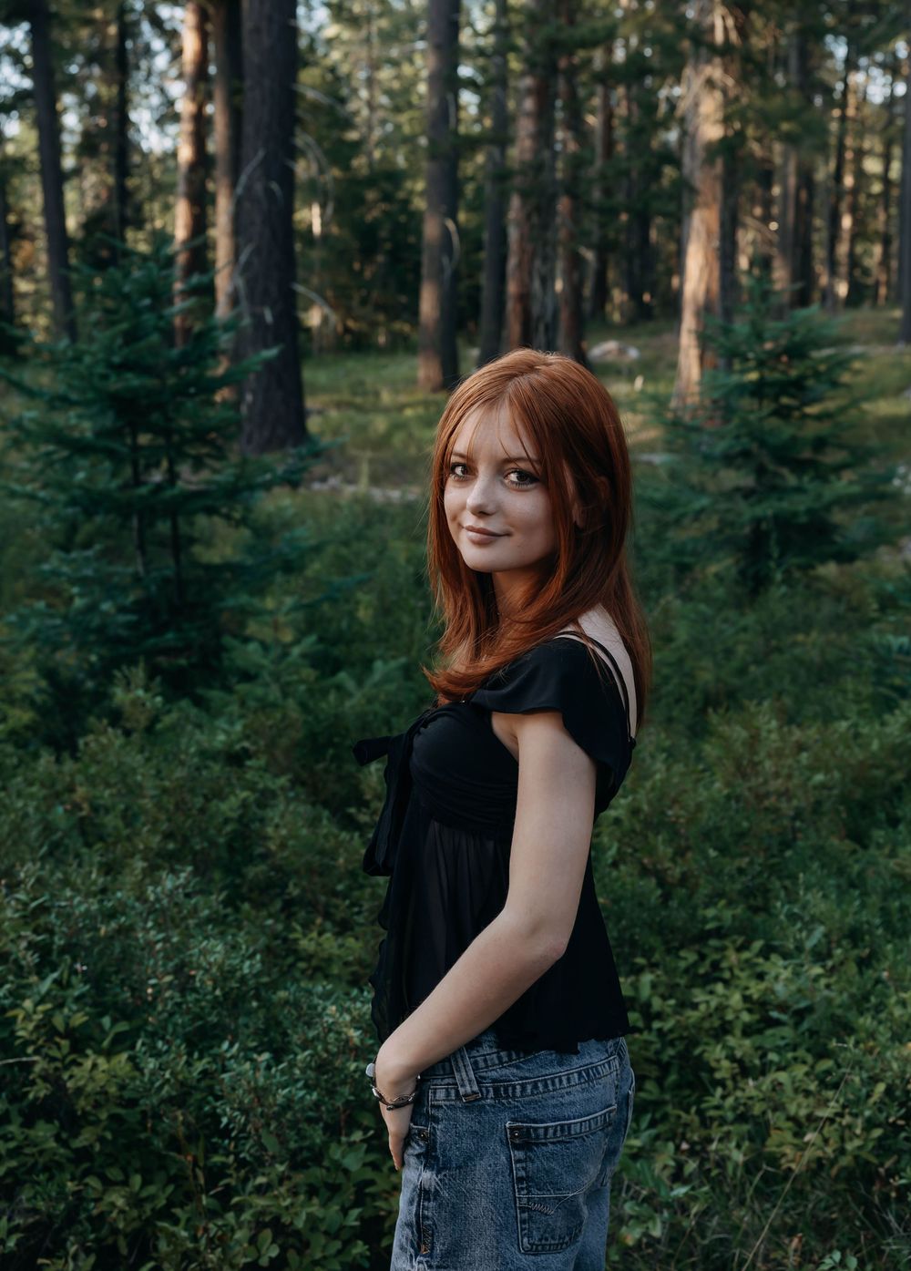 Natural forest setting with pine trees serves as backdrop for casual outdoor portraits.