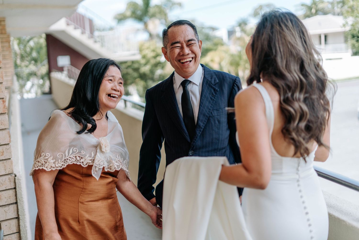A series of six wedding photos showing candid moments at an outdoor celebration in natural lighting.