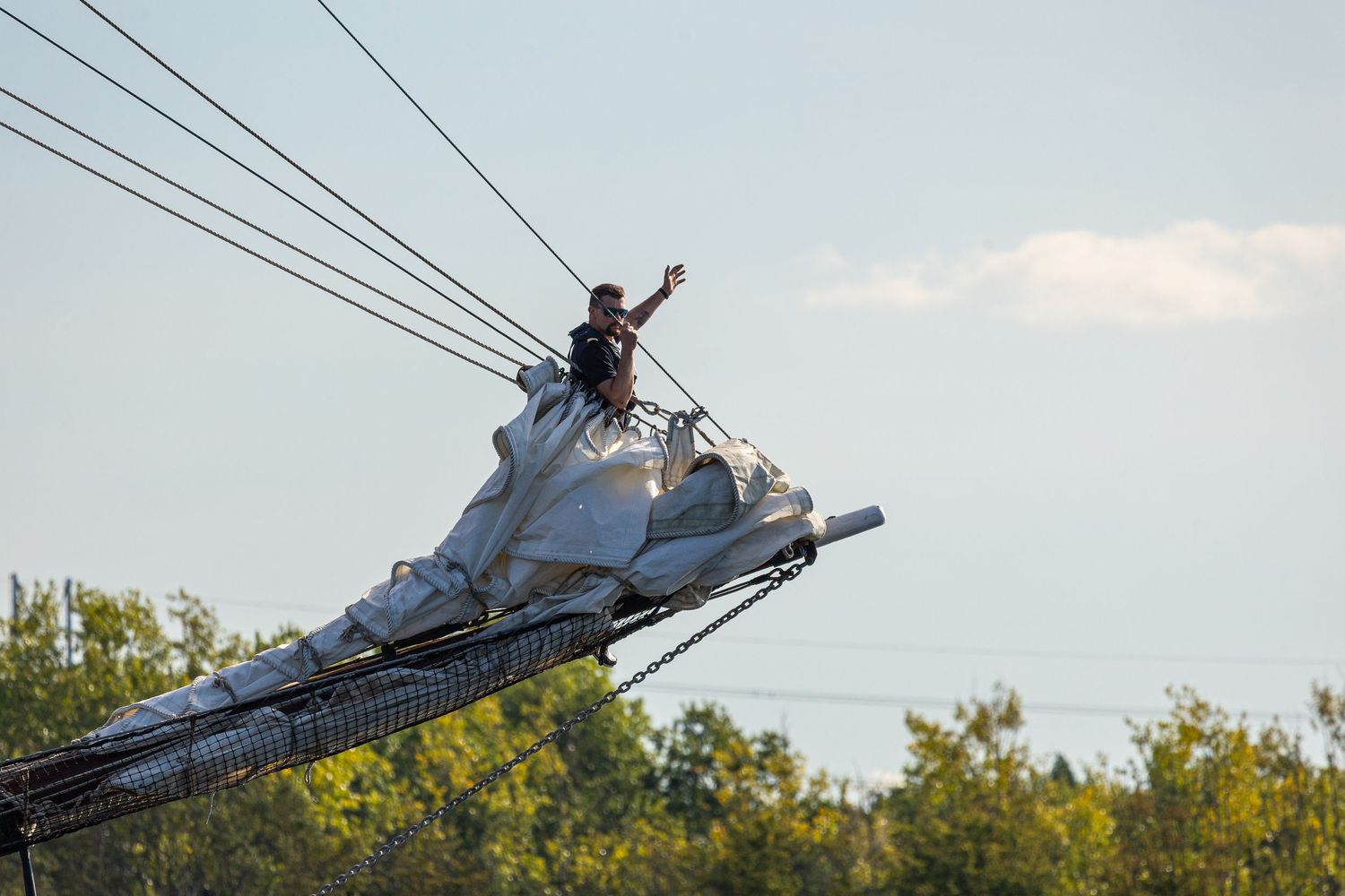 A person performs a daring stunt on a large boat ramp, jumping high into the air on a jet ski over water.